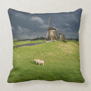 Sheep with windmills under dark clouds throw pillow