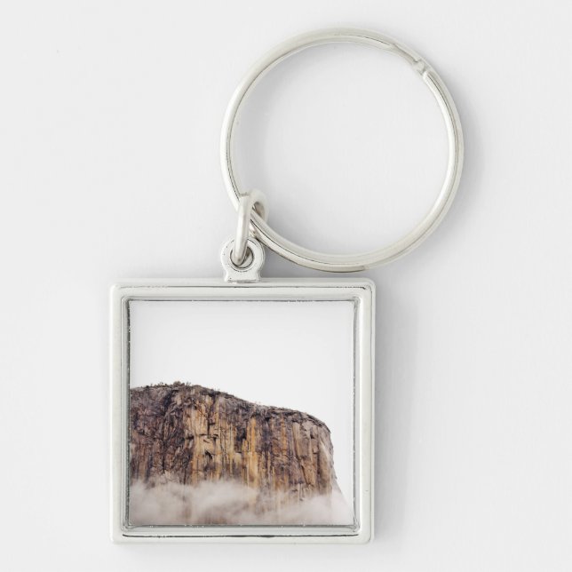 Sheer cliff rising above clouds keychain (Front)