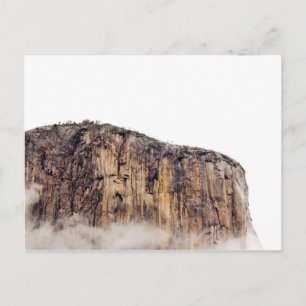 Sheer cliff rising above clouds postcard