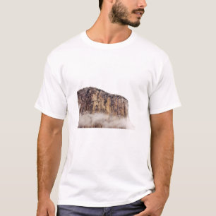 Sheer cliff rising above clouds T-Shirt