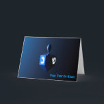Shiny Blue Dreidel Holiday Card<br><div class="desc">A modernistic,  metallic,  blue dreidel against a dark,  night-like background.  Two of the Hebrew letters found on a dreidel,  nun and shin,  glow brightly. Add  your own text.</div>