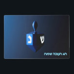 Shiny Blue Dreidel Laminated Placemat<br><div class="desc">On the front a modernistic, metallic blue dreidel against a dark, night-like background. Two of the Hebrew letters found on a dreidel, nun and shin, glow brightly. Hebrew text reading "Chag Chanukkah Sameach" (Happy Hanukkah) also appears in glowing blue and white. On the reverse side is the same image with...</div>