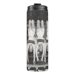 Showgirls on monkey bars, playful design. thermal tumbler