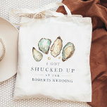 Shucked Up | Coastal Oyster Wedding Favour Tote Bag<br><div class="desc">These cheeky wedding favour tote bags feature a group of soft cream and aqua watercolor oyster and pearl illustrations, with "I got shucked up at the [name] wedding" in classic navy blue lettering. A perfect punny choice for beach themed, summer, or nautical weddings, you can easily personalize these coastal wedding...</div>