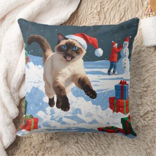 Siamese Cat Running in Snow with Christmas Hat Throw Pillow