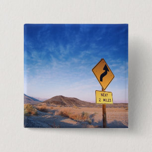 Sign on the death valley road in sunset 2 inch square button