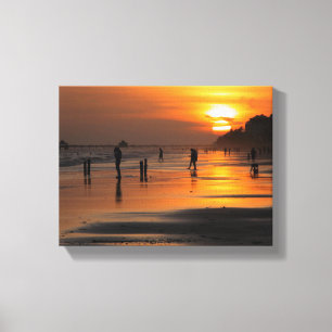 Silhouette of beach people Stretched Canvas Print
