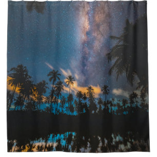 Silhouette of coconut trees reflected on body of w