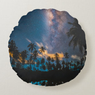 Silhouette of coconut trees reflected on body of w round pillow