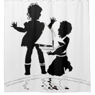 silhouette of girl and boy and model boat