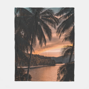 Silhouette of palm tree during golden hour fleece blanket