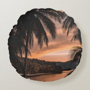 Silhouette of palm tree during golden hour round pillow