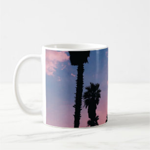 Silhouette of tree under cloudy sky coffee mug