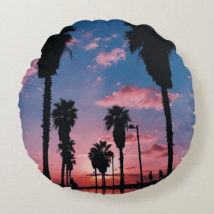 Silhouette of tree under cloudy sky round pillow