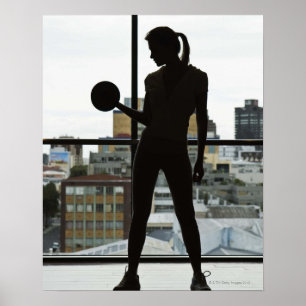 Silhouette of woman lifting weights at gym poster