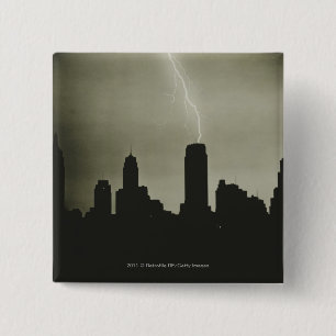 Silhouettes of skyscrapers and lightning in sky 2 inch square button