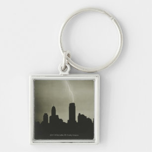 Silhouettes of skyscrapers and lightning in sky keychain
