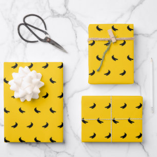 Silhouettes of Small Black Bananas on Yellow Wrapping Paper Sheet
