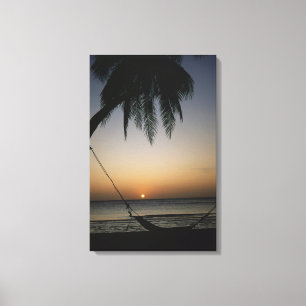 Silhuetted empty hammock at sunset canvas print