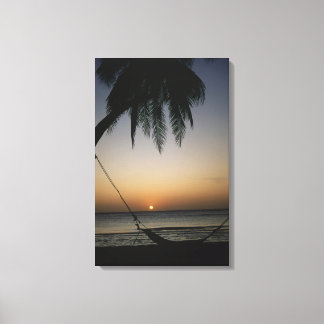 Silhuetted empty hammock at sunset canvas print