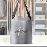 Silver Brushed Metal Black White Script Monogram  Crossbody Bag<br><div class="desc">This elegant personalized crossbody bag features a monogram and first name in modern black and white script on a silver faux brushed metal background.</div>