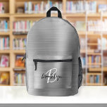 Silver Brushed Metal Black White Script Monogram  Printed Backpack<br><div class="desc">This personalized backpack features a monogram and first name in modern black and white script on an elegant silver faux brushed metal background.</div>