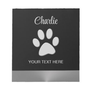 Silver Dog Paw on black background Notepad