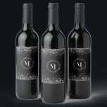 Silver Glitter And Black Elegant Monogrammed  Wine Label<br><div class="desc">Make a statement with every sip with the Monogram Silver Glitter in Black Background Wine Label. This beautifully crafted label is the perfect accessory for wine lovers who appreciate the finer things in life. The glossy black background, coupled with the shimmering silver monogram, gives your wine bottle a touch of...</div>