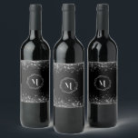 Silver Glitter And Black Elegant Monogrammed  Wine Label<br><div class="desc">Make a statement with every sip with the Monogram Silver Glitter in Black Background Wine Label. This beautifully crafted label is the perfect accessory for wine lovers who appreciate the finer things in life. The glossy black background, coupled with the shimmering silver monogram, gives your wine bottle a touch of...</div>