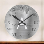 Silver Glitter Brushed Metal Monogram Name Round Clock<br><div class="desc">Silver Faux Foil Metallic Sparkle Glitter Brushed Metal Monogram Name and Initial Luxury Wall Clock. This makes the perfect sweet 16 birthday,  wedding,  bridal shower,  anniversary,  baby shower or bachelorette party gift for someone that loves glam luxury and chic styles.</div>