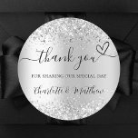 Silver glitter sparkles thank you wedding classic round sticker<br><div class="desc">Faux silver background,  decorated with faux glitter,  sparkles.  With the text: Thank you for sharing our special day,  with a small heart.   Personalize and add your names.</div>