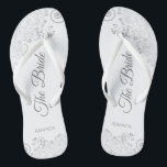 Silver Lace on White Elegant The Bride Wedding Flip Flops<br><div class="desc">Dance the night away with these beautiful wedding flip flops. Designed for the bride, they feature a simple yet elegant design with grey script lettering on a white background and fancy silver grey lace curls and swirls. Beautiful way to stay fancy and appropriate while giving your feet a break after...</div>