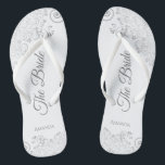 Silver Lace on White Elegant The Bride Wedding Flip Flops<br><div class="desc">Dance the night away with these beautiful wedding flip flops. Designed for the bride, they feature a simple yet elegant design with grey script lettering on a white background and fancy silver grey lace curls and swirls. Beautiful way to stay fancy and appropriate while giving your feet a break after...</div>