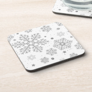 Silver snowflakes on white coaster