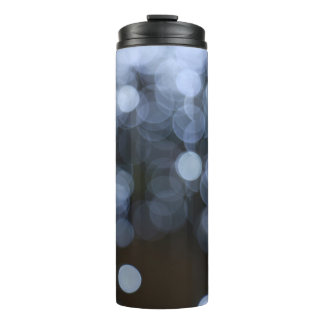 Silver, white bokeh night background. thermal tumbler