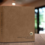 Simple Brown Leather Gold Monogram Binder<br><div class="desc">Simple monogrammed binder features a modern design with brushed metallic gold monogram emblem on a brown leather look textured background. Custom name presented in the lower right-hand corner in stylish simple font with a complimentary minimal monogram medallion. A modern binder for home or office, a professional monogrammed binder for your...</div>