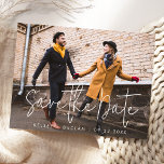 Simple Modern Script Photo Wedding Save the Date  Postcard<br><div class="desc">The front of this simple, modern Save the Date announcement postcard features a white script text overlay on a full horizontal photo of the couple, with the names and dates below in white sans serif font. Personalize the back with names, wedding date, website URL and other information, along with your...</div>
