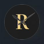 Simple Monogram Modern Black Gold Round Clock<br><div class="desc">This is a simple, modern, personalized monogram design. This stylish design is in trending black and gold with stylish typography. It's perfect for a personalized gift or ideal as a stylish new home decor accessory for yourself. Simply add your initial letter by typing it into the personalize this text box....</div>