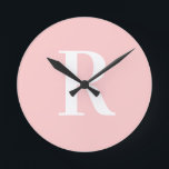 Simple Monogram Modern Blush Pink Round Clock<br><div class="desc">This is a simple, modern, personalized monogram design. This stylish design is in trending blush pink with stylish typography. It's perfect for a personalized gift or ideal as a new home decor accessory for yourself. Simply add your initial letter by typing it into the personalize this text box. Check out...</div>