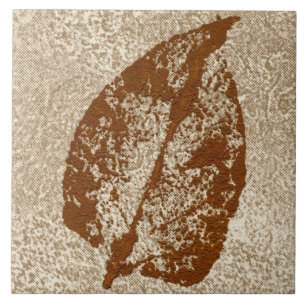 Single autumn leaf nature printed in brown on tan tile