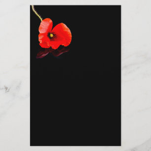Single red poppy on black flyer