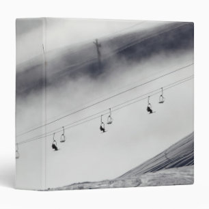 Skiers on a chair lift binder