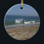 Skimboarder Success Ceramic Ornament<br><div class="desc">A mixture of balance,  muscle tone and fearlessness is required to try this difficult sport of skimboarding. This young fellow made it look (almost) easy.</div>