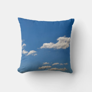Sky is blue and white clouds are passing by throw pillow