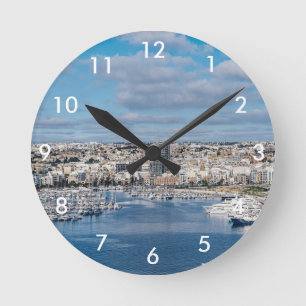 Sliema harbour with modern buildings and boats round clock