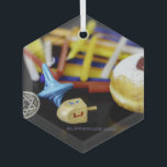 SlipperyJoe Hanukkah symbolic still life holiday e Glass Ornament<br><div class="desc">SlipperyJoe Hanukkah symbolic still life holiday essence vibrant meaningful objects colorful slender pile menorah candles artistic red blue yellow and white sufganiyah doughnut classic jelly-filled commemorate miracle of the oil dreidels metallic gold glossy blue Hebrew great miracle happened there metallic pewter star of David medallion light resilience community themes spiritual...</div>