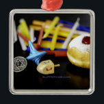 SlipperyJoe Hanukkah symbolic still life holiday e Metal Ornament<br><div class="desc">SlipperyJoe Hanukkah symbolic still life holiday essence vibrant meaningful objects colourful slender pile menorah candles artistic red blue yellow and white sufganiyah doughnut classic jelly-filled commemorate miracle of the oil dreidels metallic gold glossy blue Hebrew great miracle happened there metallic pewter star of David medallion light resilience community themes spiritual...</div>
