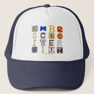 SlipperyJoe's embraces diversity cut-out letters c Trucker Hat