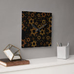 SlipperyJoe's Hanukkah-themed Star David artistic  Square Wall Clock<br><div class="desc">SlipperyJoe's Hanukkah-themed Star David artistic candlelight festive glow light and resilience themes modern reverent for Jewish holidays varying sizes metallic tones gold bronze deep brown rich black background evokes Hebrew tradition elegance symmetrical pattern gifts decorations rhythmic ceremonial visual flow significant symbol religion</div>