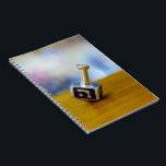 SlipperyJoe's Happy Hanukkah four-sided spinning t Notebook<br><div class="desc">SlipperyJoe's Happy Hanukkah four-sided spinning top dreidel artistic Celebration Candles Jewish Hebrew Chanukah gifts decorations Judaism religion Hebrew letter Nun traditional toy children adult game cultural symbol metallic shiny finish wooden surface</div>